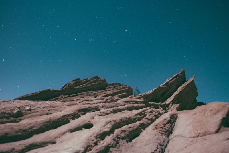 jagged rock formations meet a night sky illuminated with stars, jagged rock formations and night sky 4k