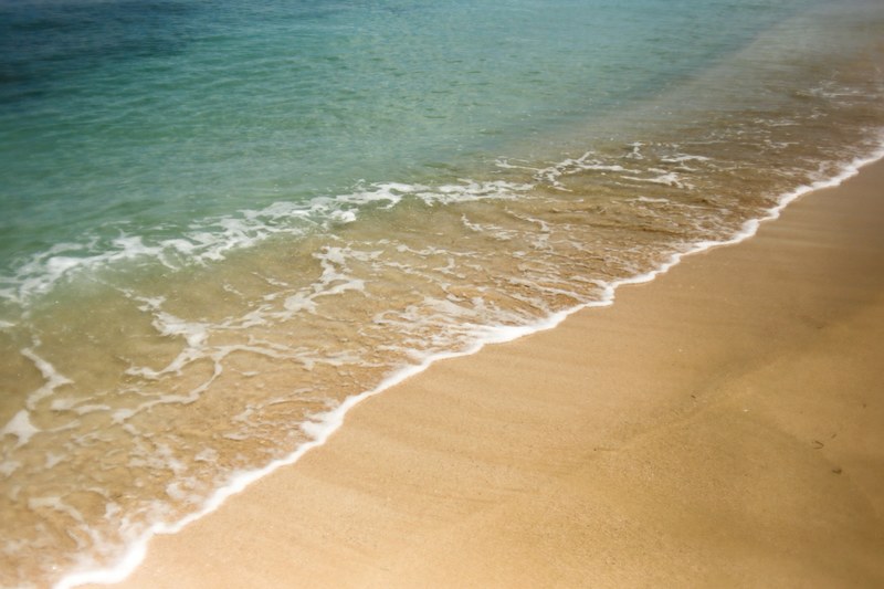clear ocean washing on the fine sand beach, ocean washing ashore 4k