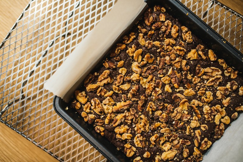 chocolate brownie dessert with walnuts cooling on a rack, fresh baked brownies 4k