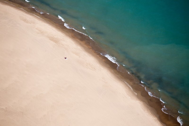 drone aerial view of a clear water washing on the clean sand shore in central michigan amp delaware, drone view of sand shoreline 4k