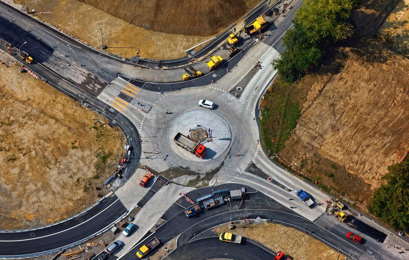 a drone shot of construction works at a traffic circle, road under construction 4k