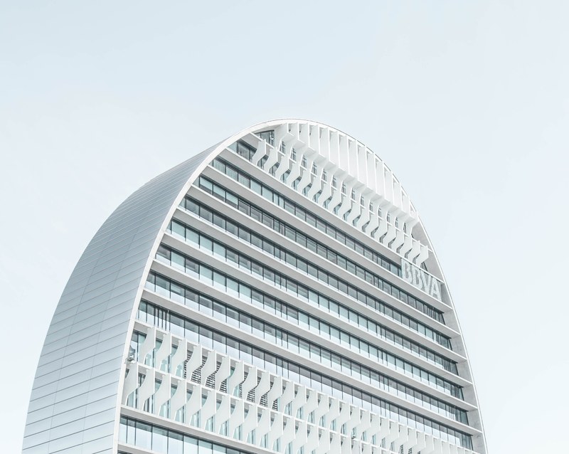 a modern skyscraper with a rounded roof in madrid, modern arched building 4k