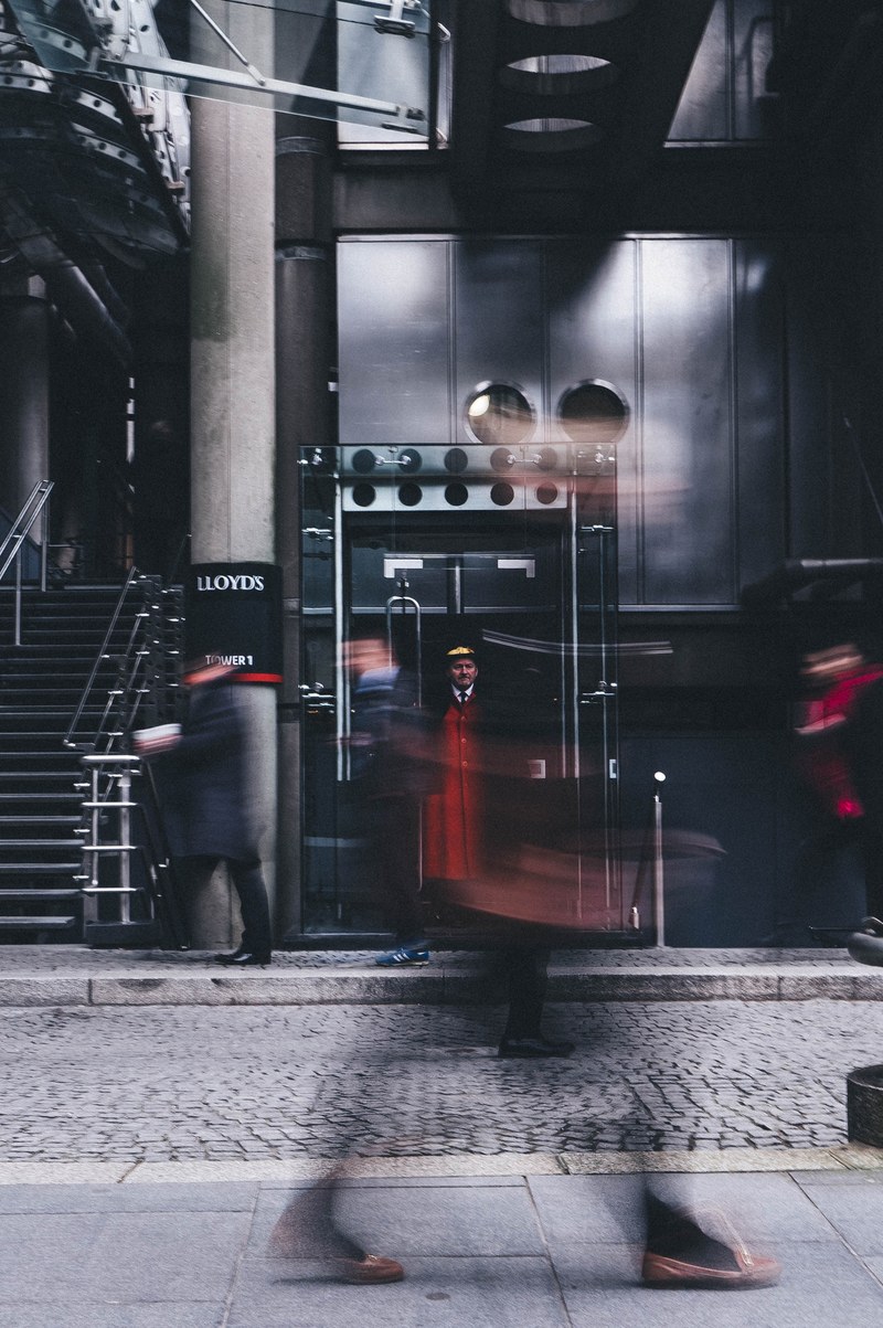 a doorman watching people pass by on leadenhall street, doorman on leadenhall street 4k