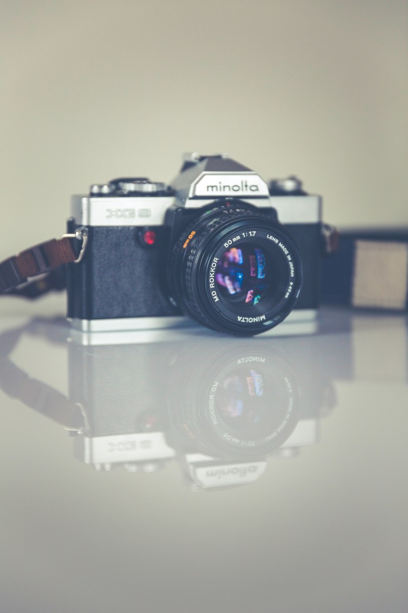 photographers vintage film camera on a reflective table, retro camera 4k