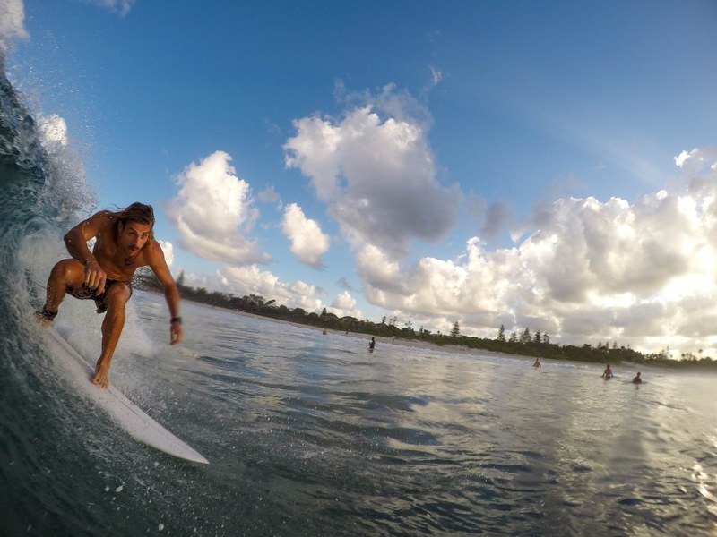 a person surfing on a small wave at a busy beach, _small wave surfer 4k