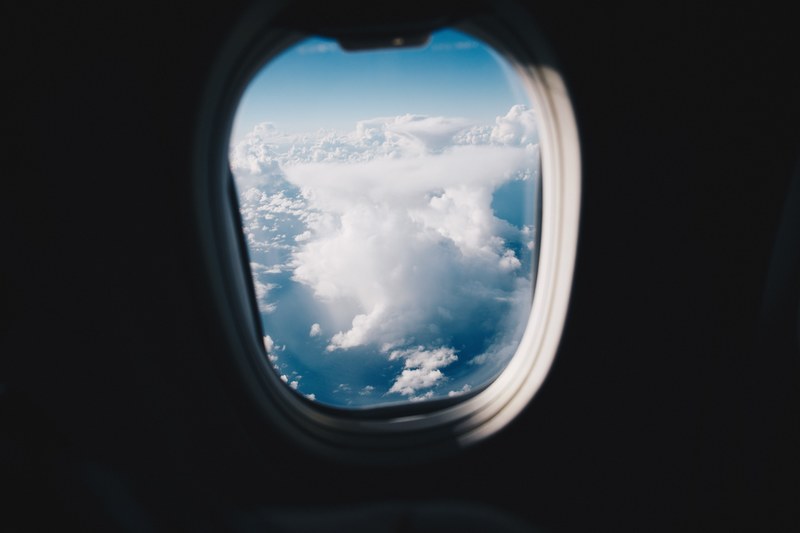 a view from an airplane window on high clouds over the tasman sea, in the air over the tasman sea 4k