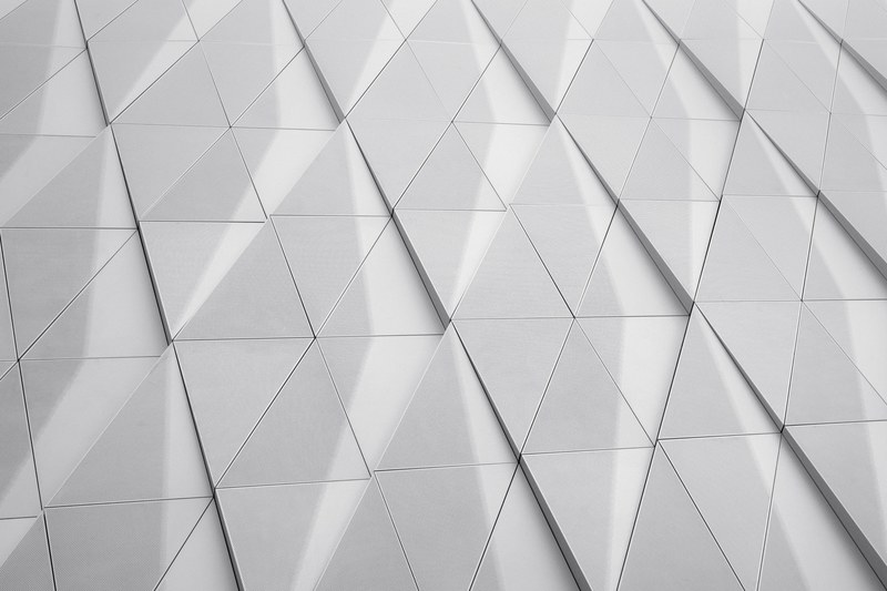 a white facade with a geometric pattern made up of triangles, triangles in a white facade 4k