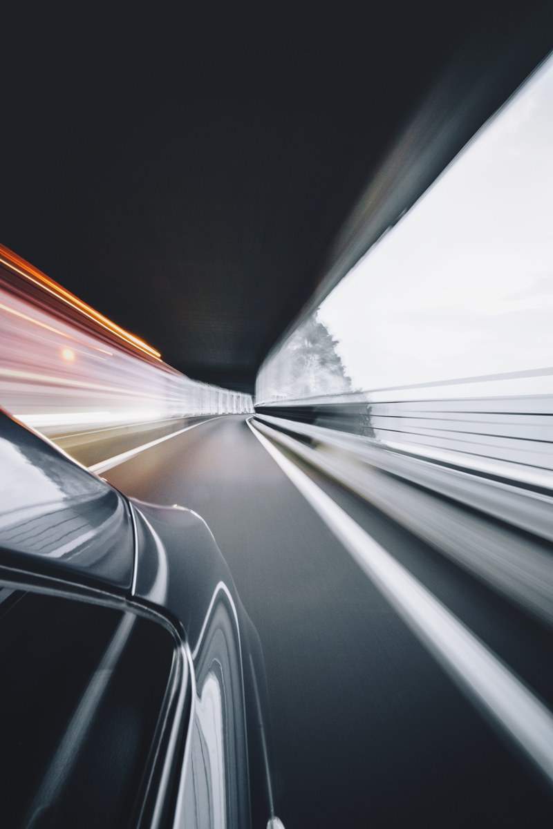 a blurry shot from the side of a fast driving car, delorean 4k