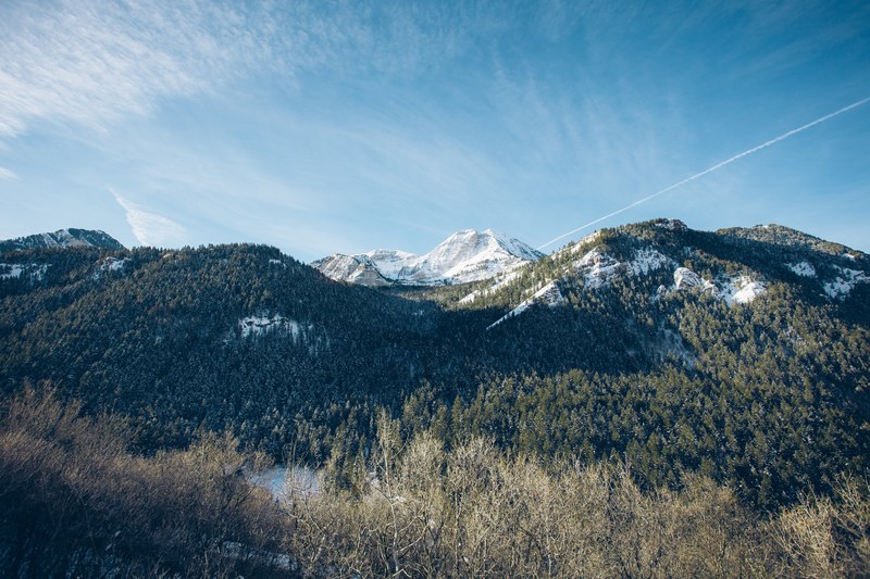 snowy mountain peak towering over wooded slopes in american fork canyon, mountain over forested slopes 4k
