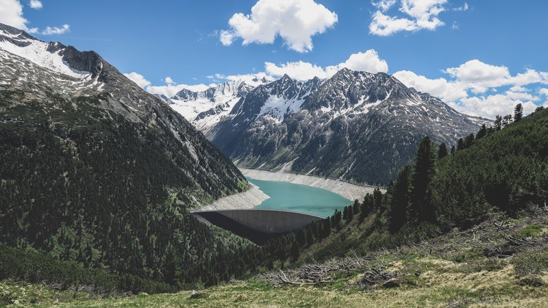 a distant view of a dam on a mountain lake, mountain lake dam 4k
