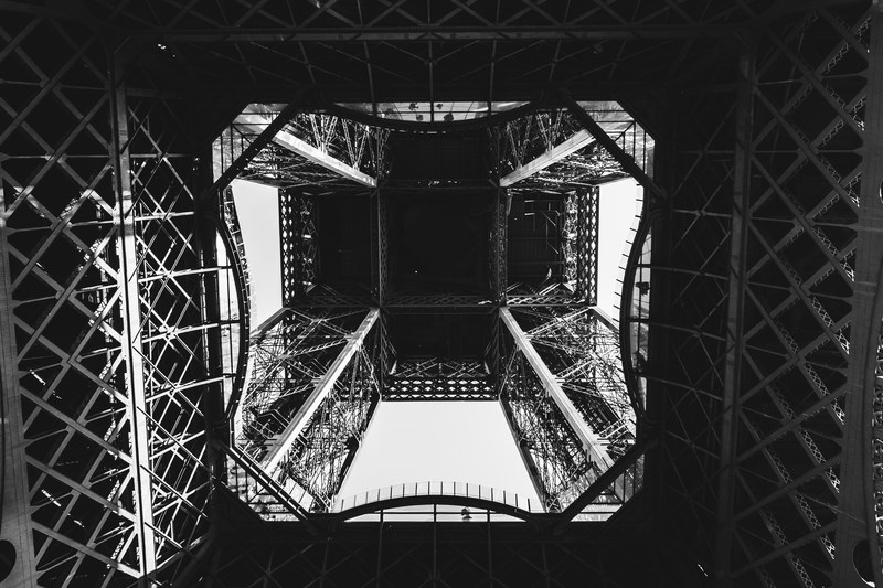 a dark photo looking directly up the eiffel tower from beneath it, _inside eiffel tower 4k