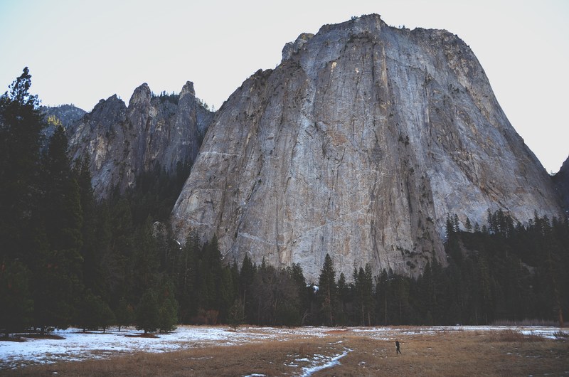 a person standing at the foot of a granite summit, at the foot of the granite giant 4k