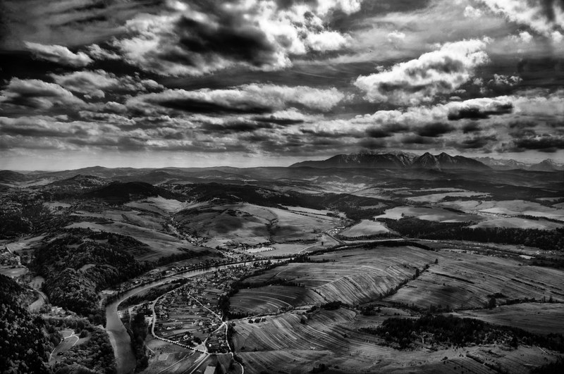 black and white panoramic shot of dramatic cloudy sky and rocky landscapetrzy korony punkt widokowy, countryside near the mountains 4k