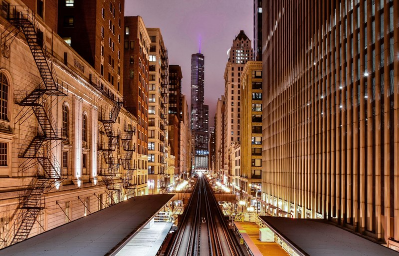 the adamswabash railway station between high rises in chicago at night, urban railway station 4k