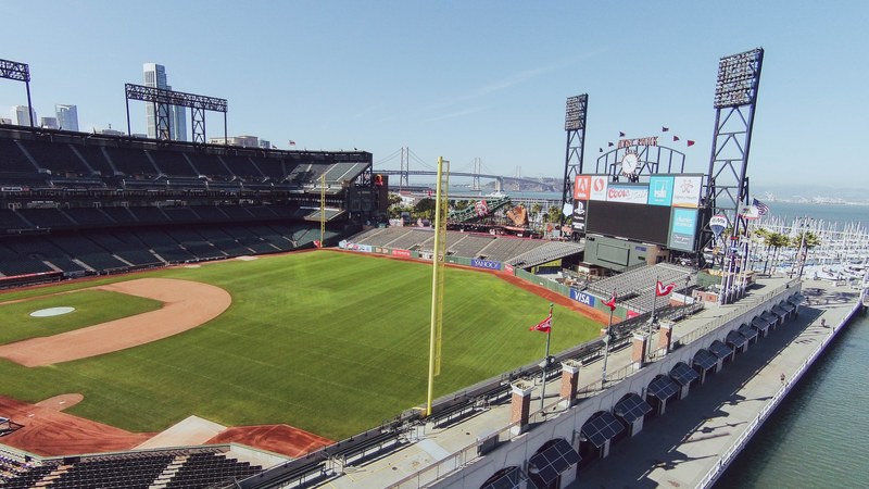 aerial view of a baseball stadium with a grass field in a city, a baseball stadium 4k