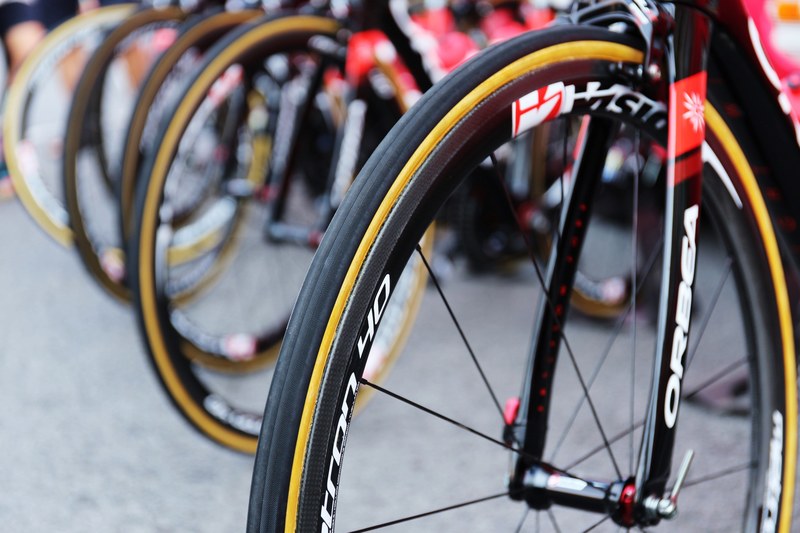 line of bike tires lined up outside, bicycle tires 4k