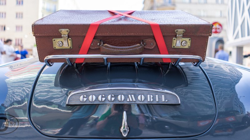 red oldtimer car and suitcase 4k