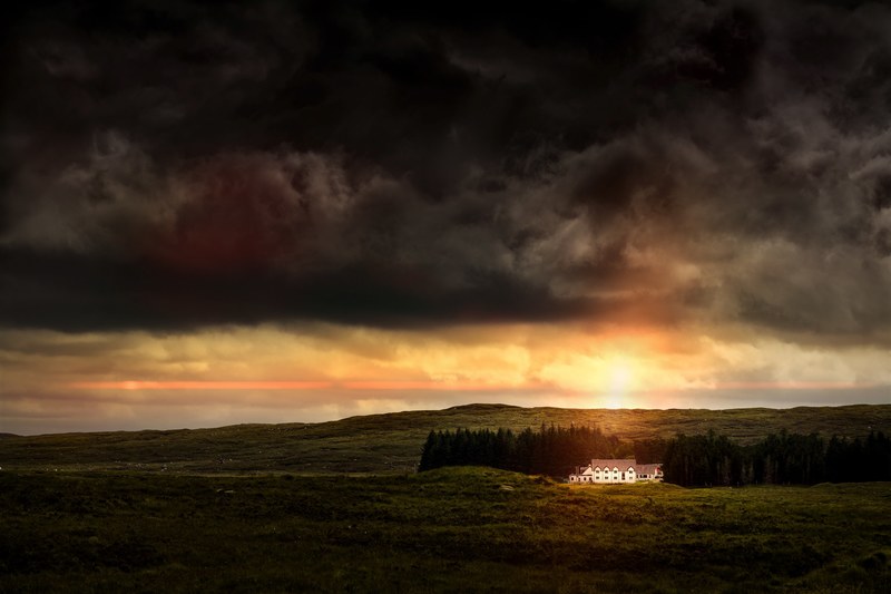 an elegant white building near a copse of trees during sunset in glencoe, dark clouds over a mansion 4k