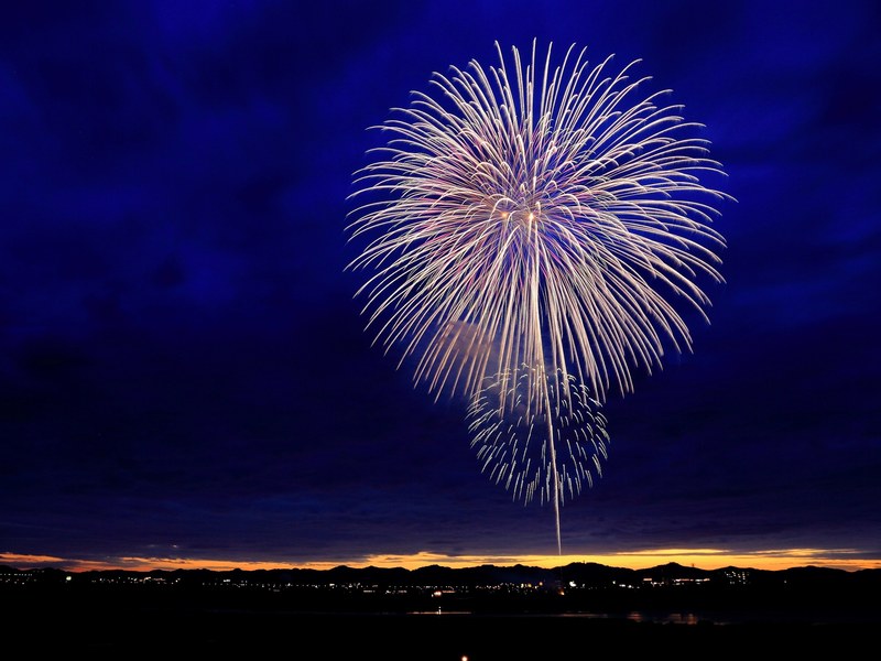 beautiful fireworks against dark clouds above a city, fireworks and dark clouds 4k