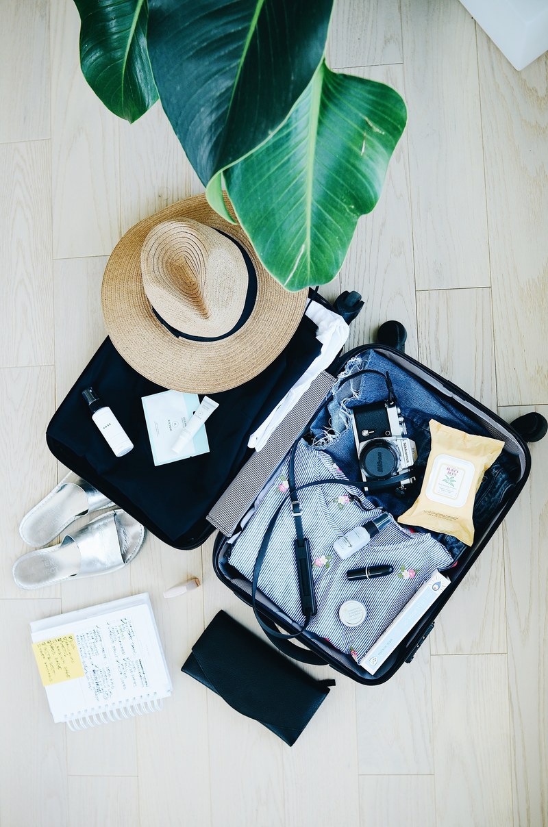 flat lay of a packed vacation suitcase, packing list 4k