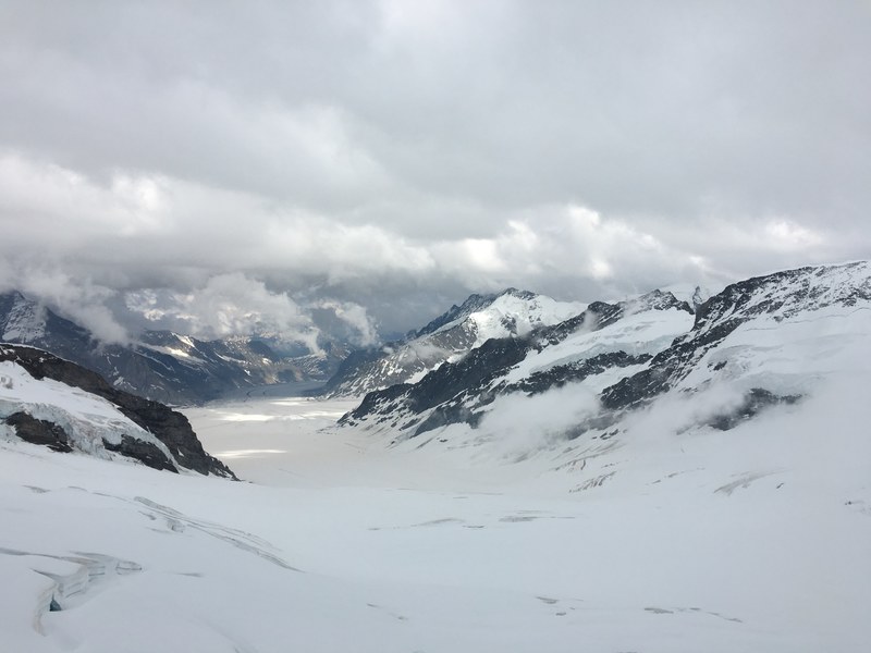 snowy mountain ridge on a cloudy winter day, clouds over a snowy mountain pass 4k