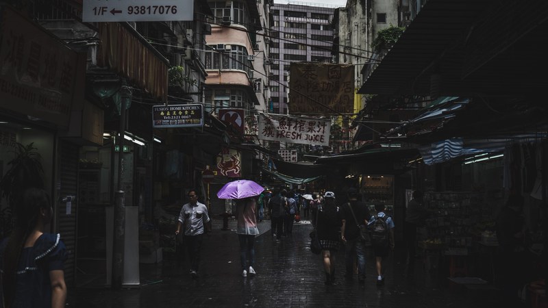 people walking in a narrow alley in kowloon on a rainy day, rainy day in a kowloon alley 4k
