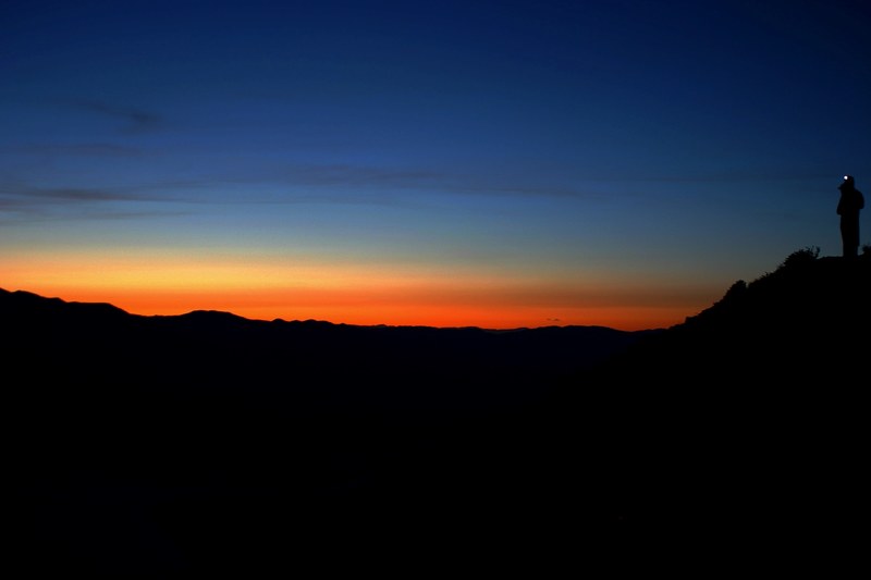 the sun rising along the horizon with a dark sky and silhouette of the skyline, horizon 4k