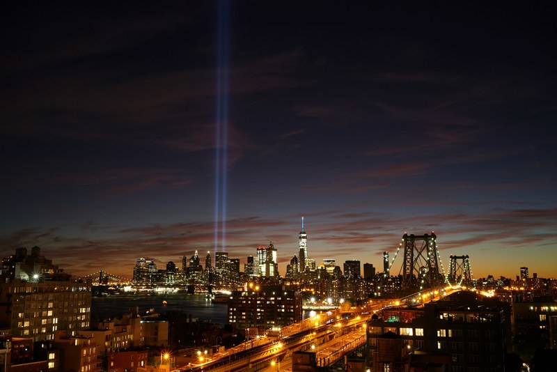 new york citys brooklyn bridge and city skyline with lights glowing at sunset, light bridge sunset and city 4k