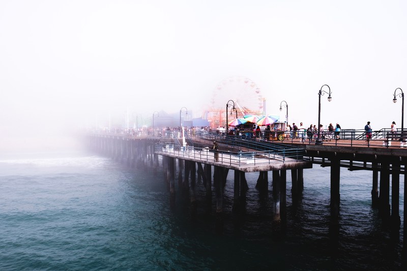colorful carnival on a foggy day on the venice beach boardwalk, boardwalk carnival 4k