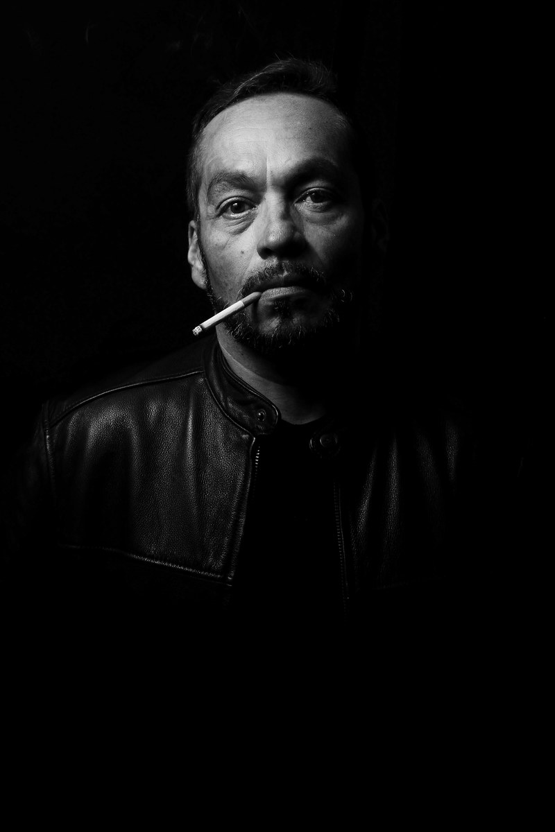 a man smoking a cigarette in the dark wearing a leather jacket in san jos, man smoking in the dark 4k