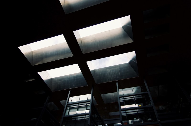 skylight window from below in dark industrial room at museo nacional centro de arte reina sofa, black building architecture 4k