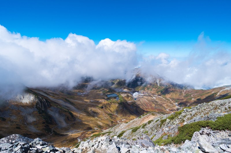 a colorful mountain landscape near mount tate seen from a rocky slope, clouds over mount tate 4k