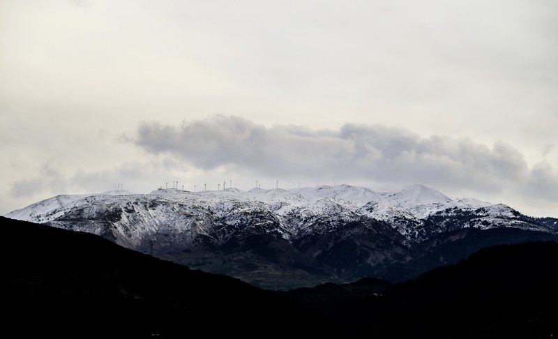a wind farm on snow topped mountains in drepano, wind farm in the mountains 4k