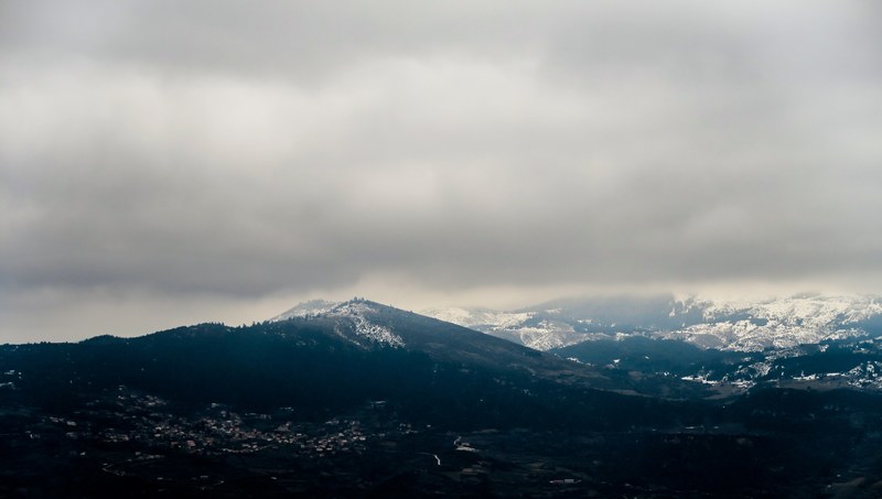 a rural area in the mountains under dense clouds, mountainous countryside on a cloudy day 4k