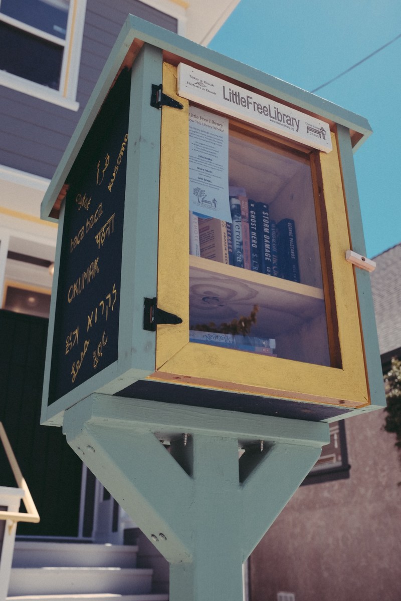 little free library stand with clear door and library books inside and writing on exterior, little free library stand 4k