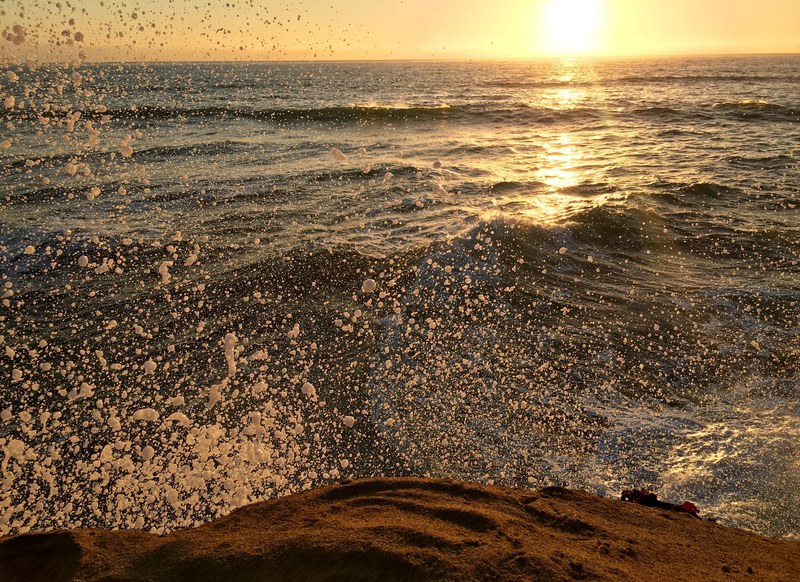 water splashing into sunset cliffs coastline as the sun sets, sunset cliffs splashing coastline 4k