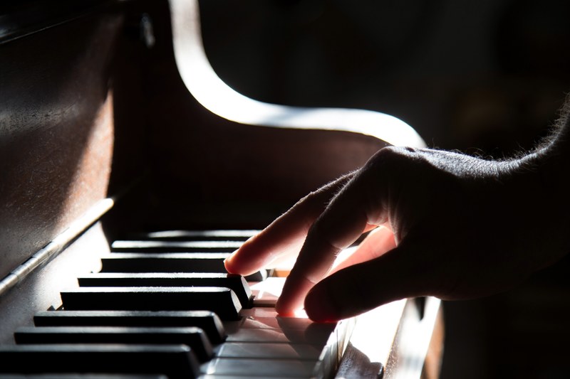 a person playing the piano in the light, piano time 4k