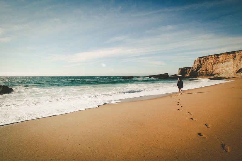 lone woman enjoys walk on the beach in idyllic paradise view, woman in beach paradise 4k