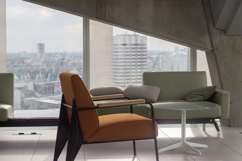 a chair a coffee table and a sofa next to a floor to ceiling window and a bare wall, coffee table corner in a london apartment 4k