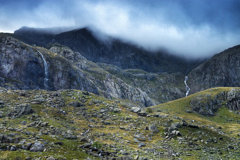 two waterfalls streaming down jagged rocks in the mist shrouded mountains, two mountain waterfalls 4k