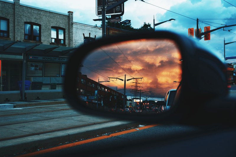 the view of an orange sky and the road from a side mirror on a car in toronto, toronto side view mirror 4k