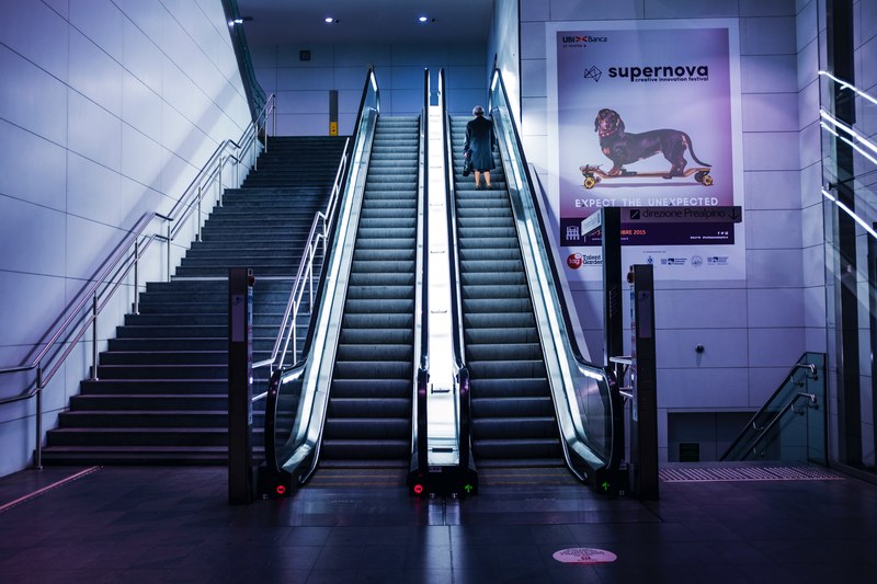 underground escalator with modern architecture with a poster on the wall of a dog, underground escalator 4k
