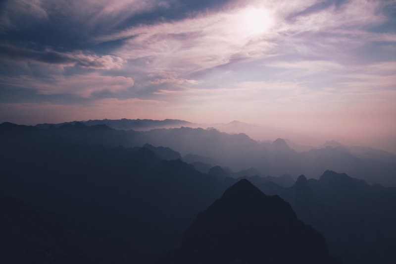 silhouettes of mountain ridges in pink hued sunshine during sunset, mountains in pink sunshine 4k