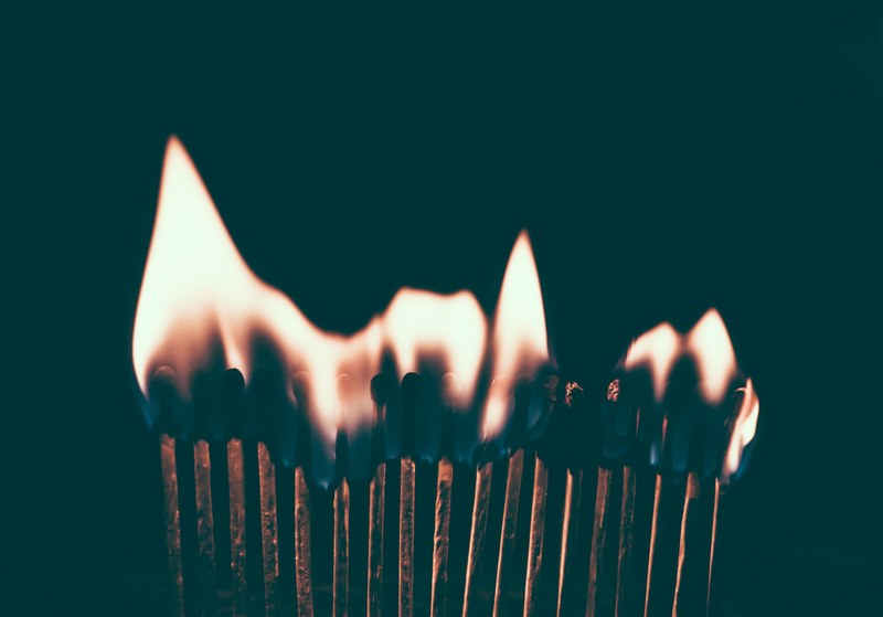 flames ignite on a line of burning matches in the dark, matchstick in the dark 4k