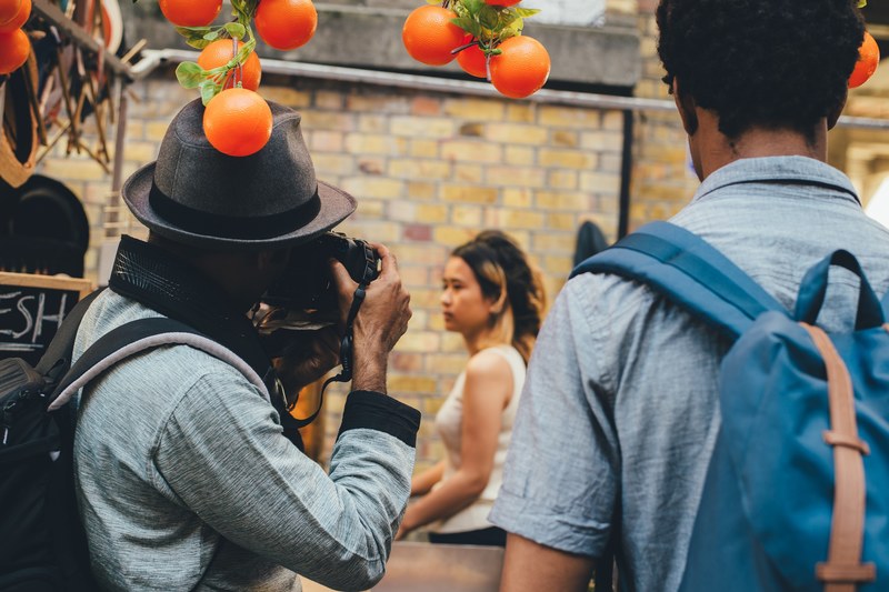 photowalk holding hat and camera 4k