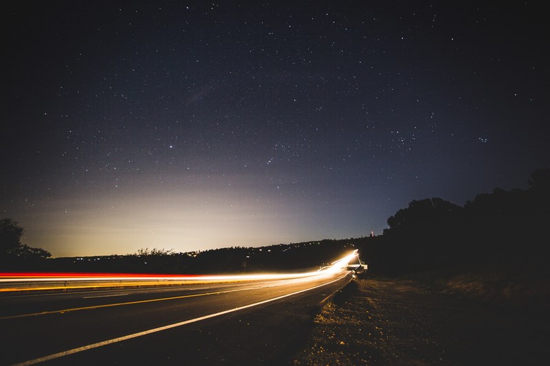 a night time shot of headlight trails from traffic passing by foresthill bridge, light trails around foresthill bridge 4k