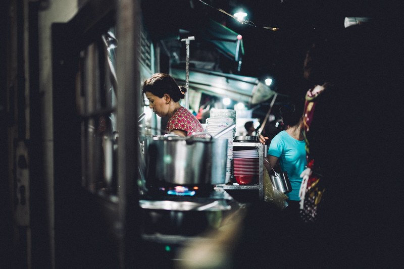 a woman cooks food at street food night market in ho chi minh city, street food life 4k