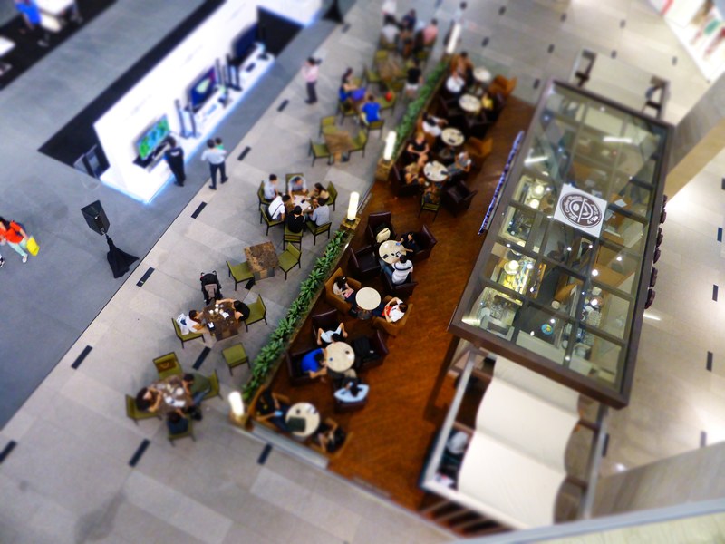 an overhead shot of people at a table in a shopping mall cafeteria, shopping mall cafeteria 4k