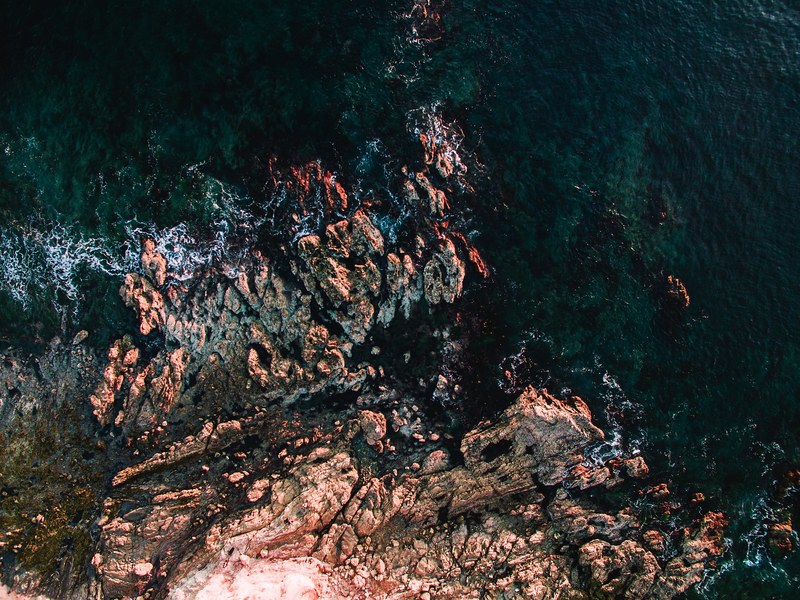 drone aerial view of the rocky coastline at corona del mar, waves 4k