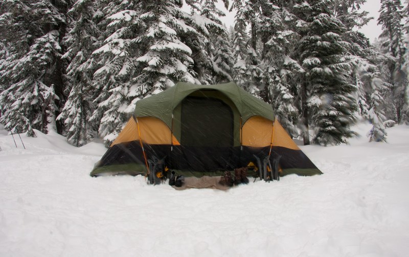 a green and orange tent for camping in the snow at stevens pass washington, a tent in the snow at stevens pass 4k